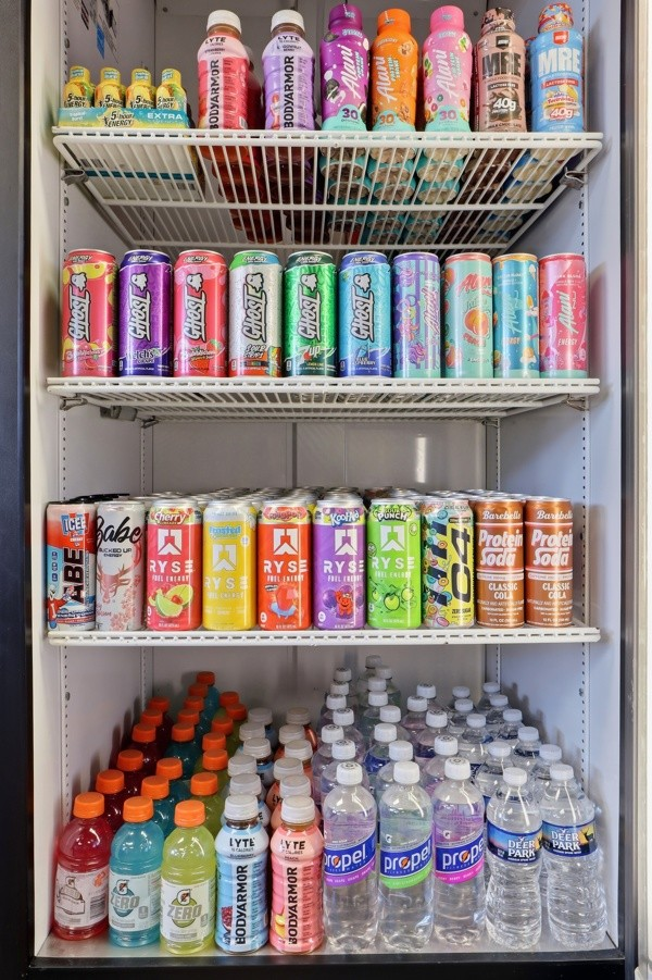 Cooler stocked with energy drinks, protein sodas, sports drinks and water