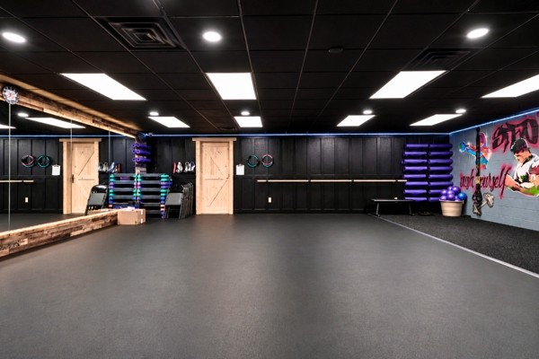 Studio floor with barn doors, equipment racks and mirrored wall