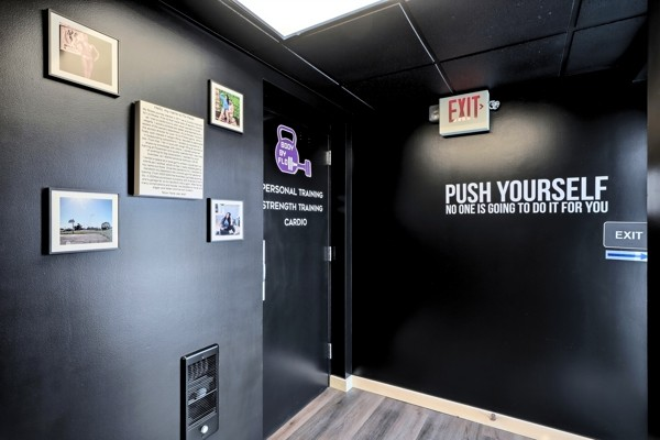 Interior hallway at BodyByFlo with framed member photos