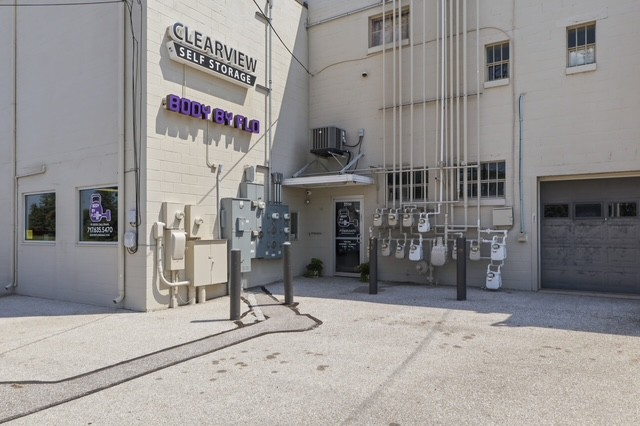 Exterior of the building housing BodyByFlo, with signage above the side entrance