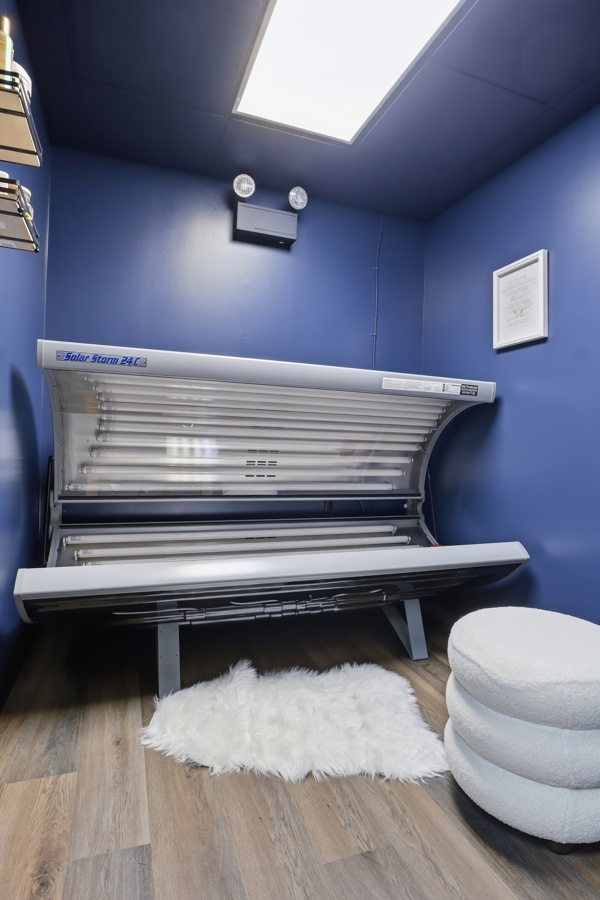 Solar Storm tanning bed in a private blue tanning room