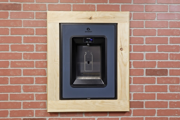 Filtered bottle-filling water station set into a brick wall